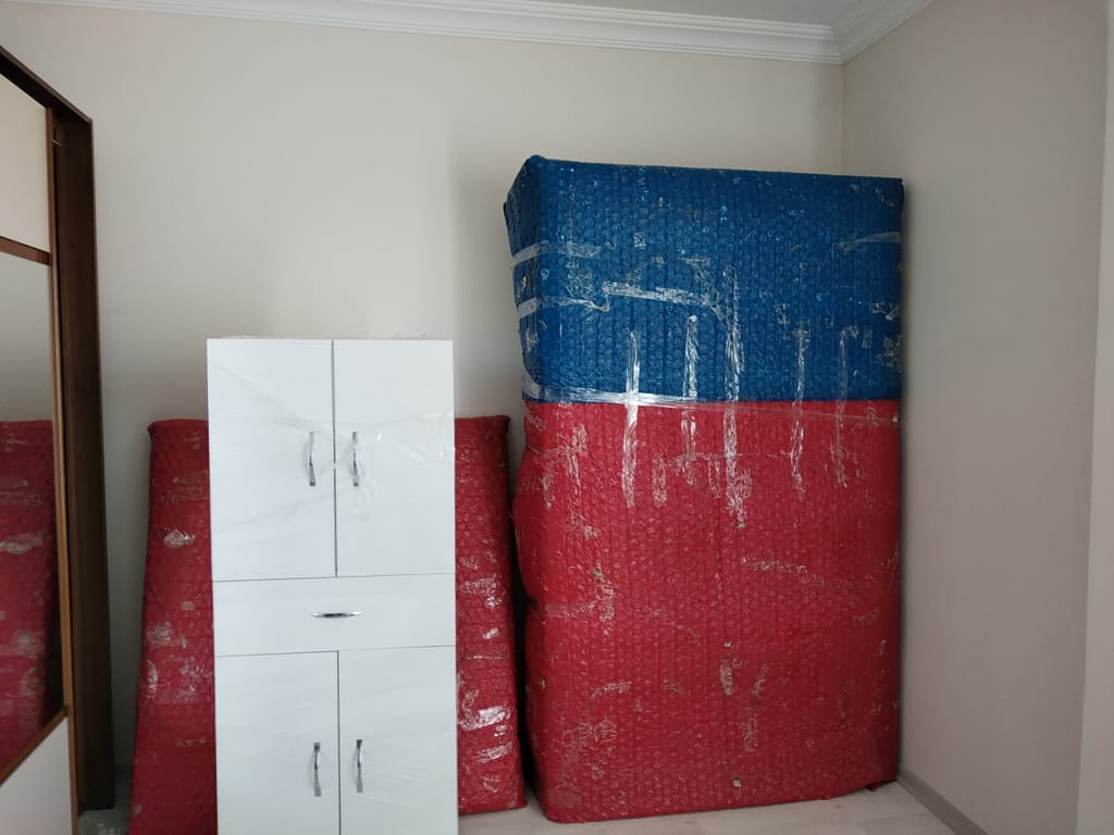 Ortahisar pelitli evden eve nakliyat Trabzon çözümleri, kırmızı ve mavi baloncuklu naylon ile yatak odası dolabını söküp sardık